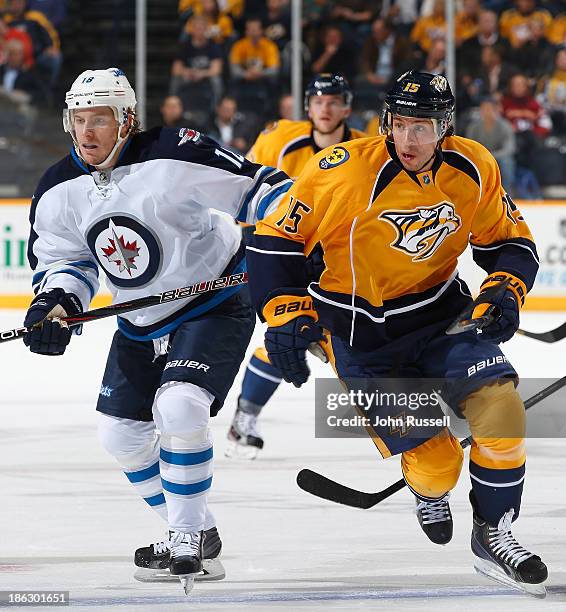 Craig Smith of the Nashville Predators skates against Bryan Little of the Winnipeg Jets at Bridgestone Arena on October 24, 2013 in Nashville,...