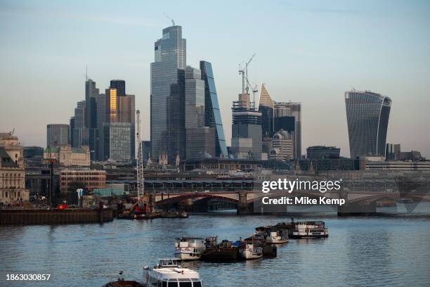 City of London skyline looking over the River Thames past moored boats on 6th December 2023 in London, United Kingdom. The City of London is a city,...