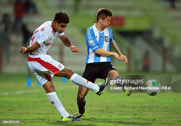 Nicolas Tripichio of Argentina battles with Nidhal Ben Salem of Tunisia during the FIFA U-17 World Cup UAE 2013 round of 16 match between Argentina...