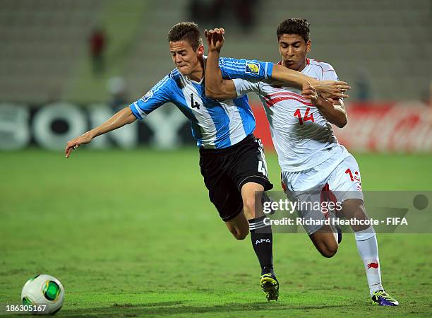 Nicolas Tripichio of Argentina battles with Nidhal Ben Salem of Tunisia during the FIFA U-17 World Cup UAE 2013 round of 16 match between Argentina...