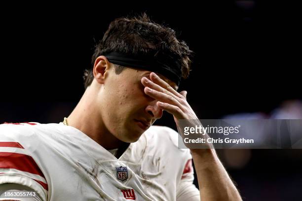 Tommy DeVito of the New York Giants reacts as he walks off the field after the game against the New Orleans Saints at Caesars Superdome on December...