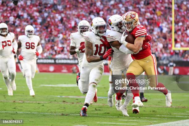 Christian McCaffrey of the San Francisco 49ers runs with the ball during the first quarter against the Arizona Cardinals at State Farm Stadium on...