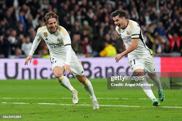 Luka Modric of Real Madrid celebrates with teammate Brahim Diaz after scoring the team's fourth goal during the LaLiga EA Sports match between Real...