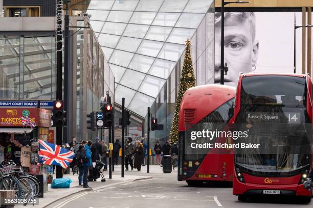 Christmas shoppers and digital advertising at Tottenham Court Road on 20th December 2023, in London, England.