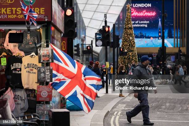 Christmas shoppers and digital advertising at Tottenham Court Road on 20th December 2023, in London, England.