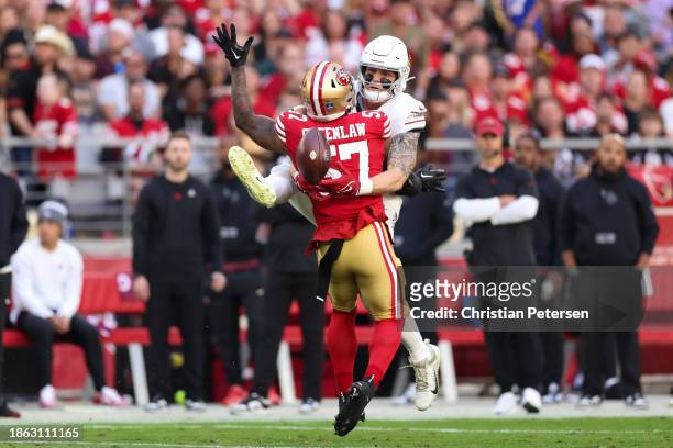 Trey McBride of the Arizona Cardinals attempts to make a catch around Dre Greenlaw of the San Francisco 49ers during the first quarter at State Farm...