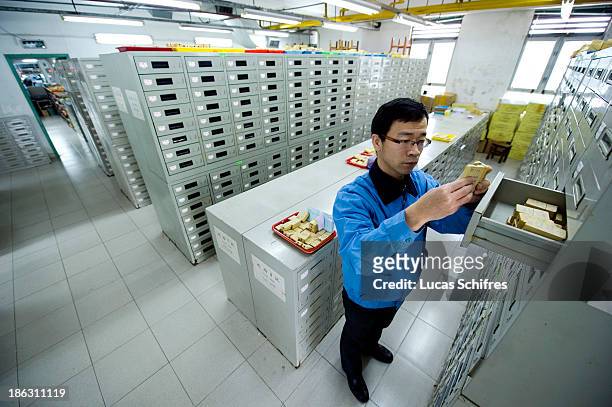 Worker takes a jewel rubber mold from the rubber moulds archives of a jewel factory, on January 26, 2011 in the district of Panyu of Guangzhou city,...