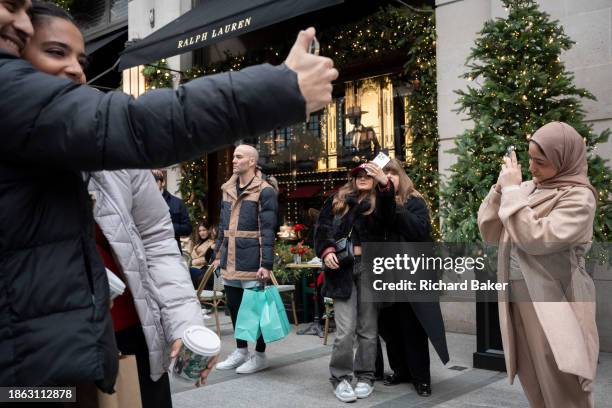 Christmas shoppers outside Ralph Lauren on New Bond Street on 20th December 2023, in London, England.