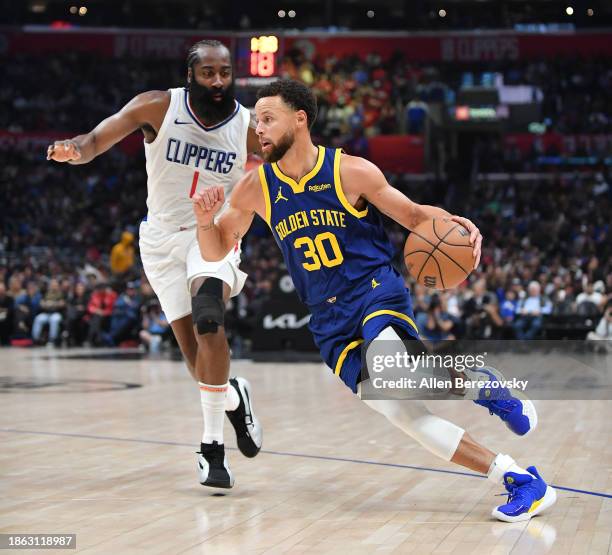 Stephen Curry of the Golden State Warriors dribbles the ball against James Harden of the LA Clippers during the first half of the game at Crypto.com...