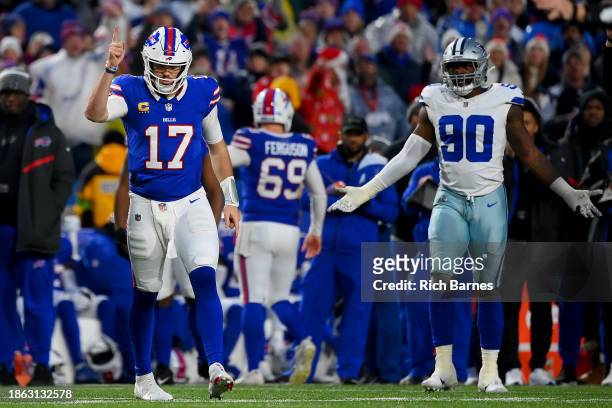 Josh Allen of the Buffalo Bills and DeMarcus Lawrence of the Dallas Cowboys react after Dallas is called for roughing the passer, resulting in a...