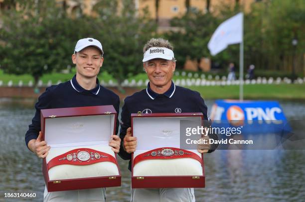 Bernhard Langer of Germany and his son Jason Langer hold their winner's belts after their win in the final round of the PNC Championship at The...