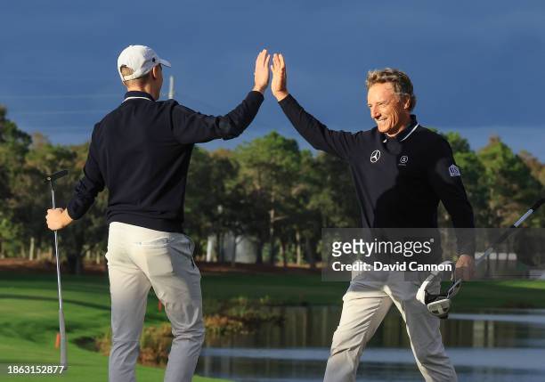 Bernhard Langer of Germany and his son Jason Langer celebrate after holing their final putt on teh 18th hole to secure their win in the final round...