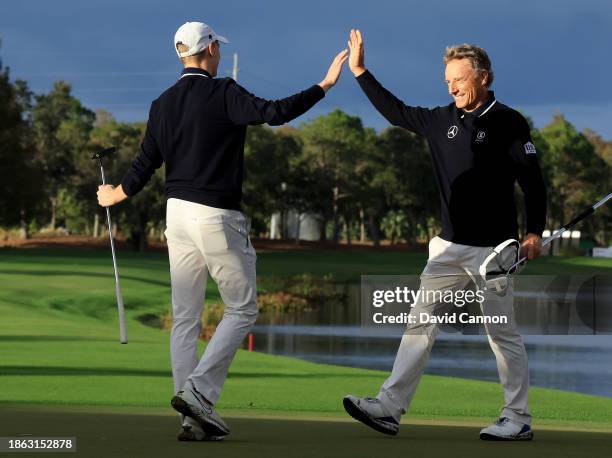 Bernhard Langer of Germany and his son Jason Langer celebrate after holing their final putt on teh 18th hole to secure their win in the final round...