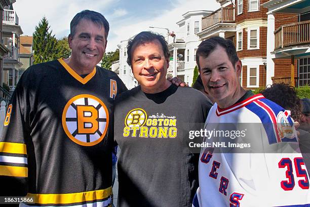 Mike Richter of the New York Rangers and Cam Neely of the Boston Bruins pose with film director Bobby Farrelly on the set of the 2013 Discover NHL...