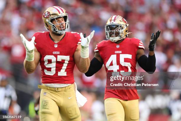 Nick Bosa celebrates with Demetrius Flannigan-Fowles of the San Francisco 49ers after sacking Kyler Murray of the Arizona Cardinals during the first...