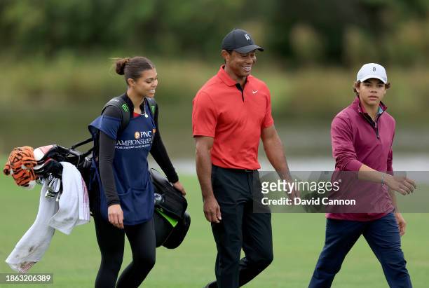 Tiger Woods of The United States walks down the 14th hole with his son Charlie Woods and his daughter Sam Woods who was caddying for him during the...