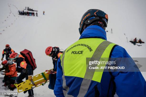 High mountain rescue police officer takes part in a search and rescue exercise for avalanche victims in the French Alps ski resort of Les Deux Alpes,...