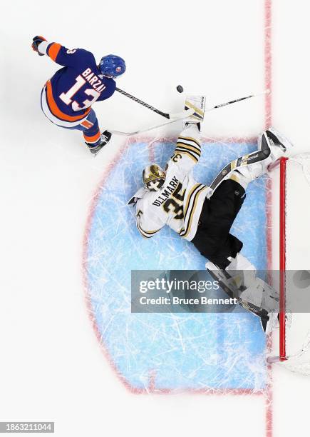 Linus Ullmark of the Boston Bruins makes the save on Mathew Barzal of the New York Islanders on the shootout at UBS Arena on December 15, 2023 in...