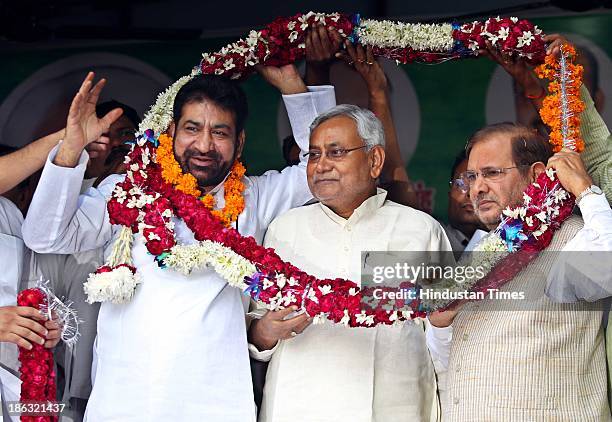 Bihar Chief Minister Nitish Kumar and JD President Sharad Yadav with Shoaib Iqbal, Lok Janshakti Party MLA from Matia Mahal in event in which he and...