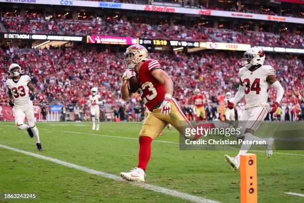 Christian McCaffrey runs for a touchdown after hauling in a 41-yard pass from Brock Purdy of the San Francisco 49ers during the third quarter of a...