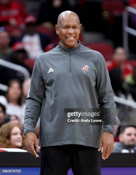 Kenny Payne the head coach of the Louisville Cardinals gives instructions to his team in against the Pepperdine Waves at KFC YUM! Center on December...