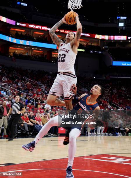 Tre White of the Louisville Cardinals dunks the ball against the Pepperdine Waves at KFC YUM! Center on December 17, 2023 in Louisville, Kentucky.