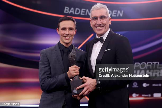 Eric Frenzel poses with his Prize for "Role models in Sport" next to Walter Strohmaier, Vize Präsident of the German Sparkassen and Giro savings bank...
