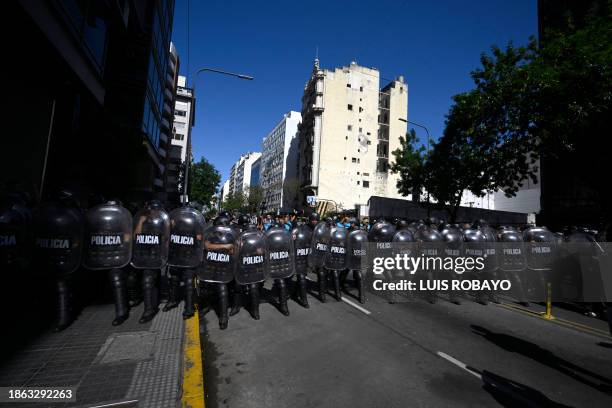 Line of riot police prevent protesters from marching in the roadway during the first demonstration against the new government of Javier Milei in...