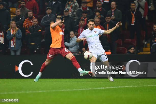 Baris Alper Yilmaz of Galatasaray and Frederic Veseli of Fatih Karagumruk battle for the ball during the Turkish Super League match between...