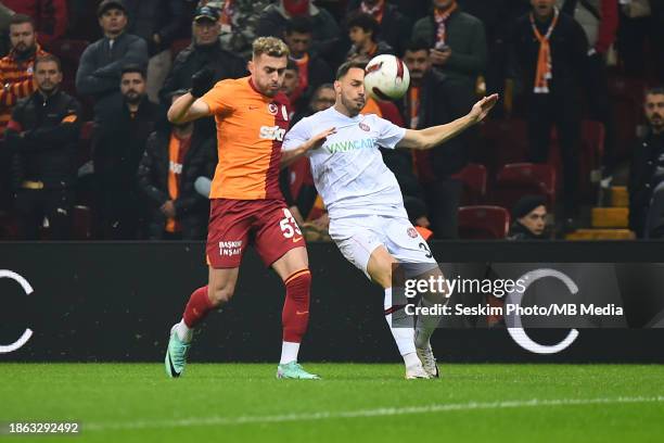 Baris Alper Yilmaz of Galatasaray and Frederic Veseli of Fatih Karagumruk battle for the ball during the Turkish Super League match between...