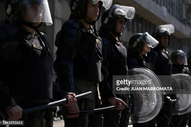 Members of the Argentine National Gendarmerie stand guard during the first demonstration against the new government of Javier Milei at Plaza de Mayo...