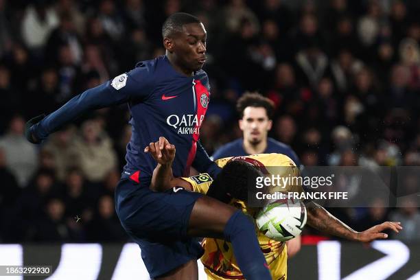 Paris Saint-Germain's French forward Randal Kolo Muani fights for the ball with Metz' French defender Christophe Herelle during the French L1...