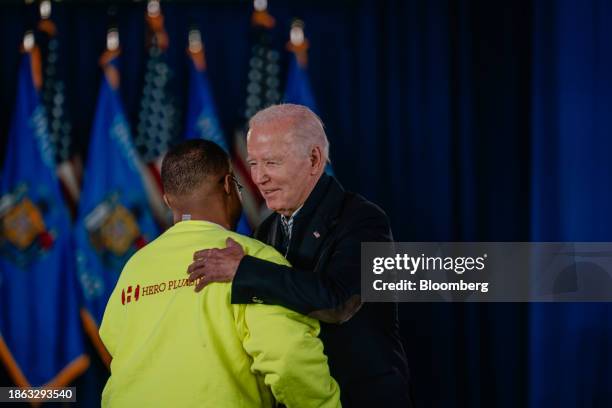 Rashawn Spivey, chief executive officer of Hero Plumbing, left, embraces US President Joe Biden as he arrives at an economic event at the Wisconsin...