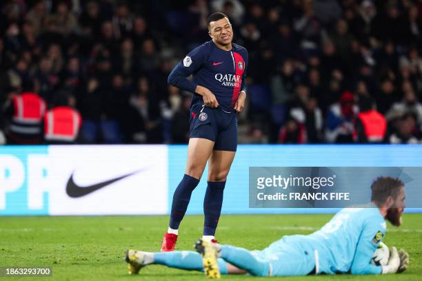 Paris Saint-Germain's French forward Kylian Mbappe reacts after missing a goal opportunity during the French L1 football match between Paris...