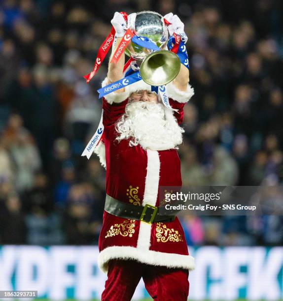Santa parades the Viaplay Cup during a cinch Premiership match between Rangers and St Johnstone at Ibrox Stadium, on December 20 in Glasgow, Scotland.