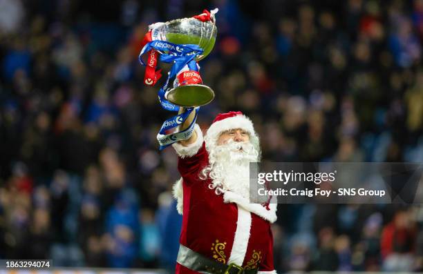 Santa parades the Viaplay Cup during a cinch Premiership match between Rangers and St Johnstone at Ibrox Stadium, on December 20 in Glasgow, Scotland.