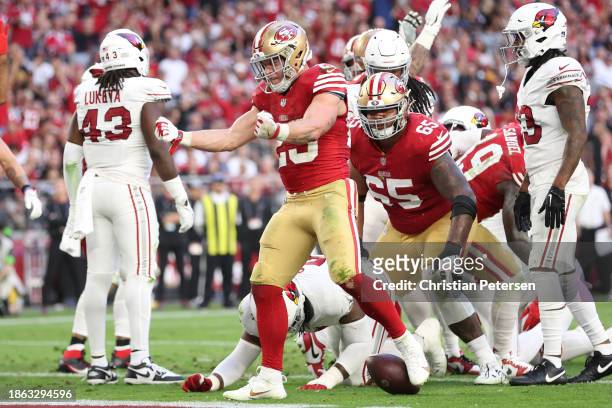 Christian McCaffrey of the San Francisco 49ers reacts after scoring a touchdown during the third quarter of a game against the Arizona Cardinals at...