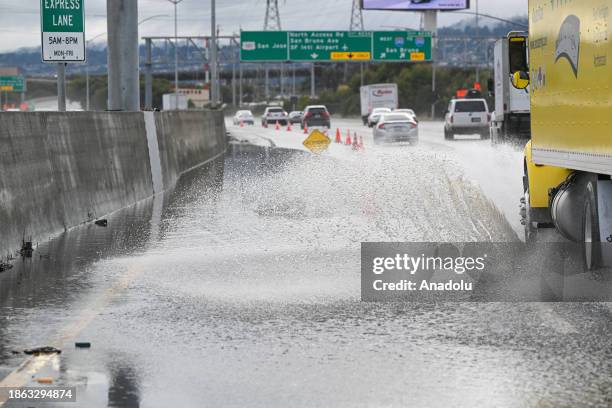 Left lane is closed as cars commute on Highway 101 near the San Francisco International Airport as heavy rain hits in South San Francisco,...