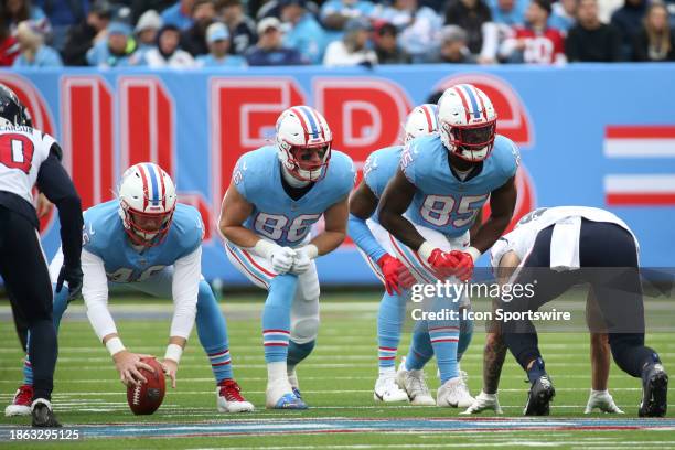 Tennessee Titans long snapper Morgan Cox prepares to snap, as Tennessee Titans tight end Kevin Rader and Tennessee Titans tight end Chigoziem Okonkwo...