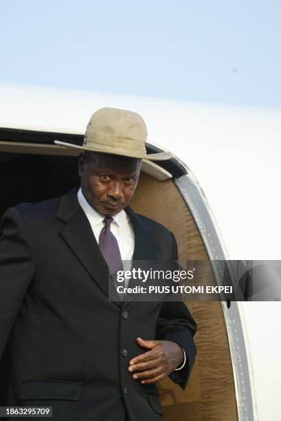 Ugandan President Yoweri Museveni alights from his aircraft at the Nnamdi Azikiwe International Airport in Abuja 04 December 2003 to attend the...
