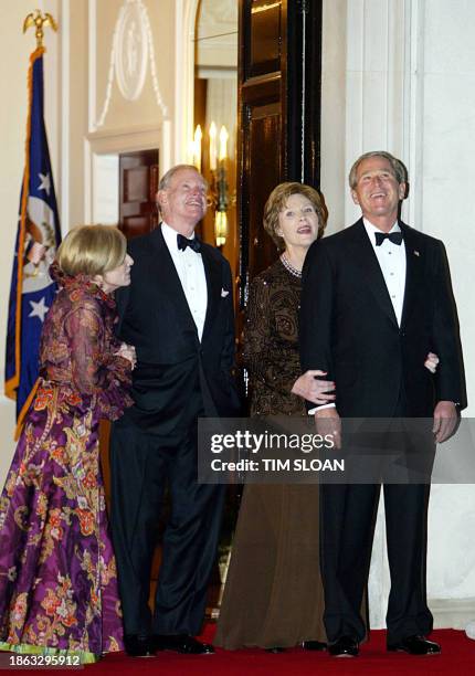 Waiting for the Queen, First Lady Laura Bush holds onto her husband US President George W. Bush with US Ambassador to Britain William S. Farish and...