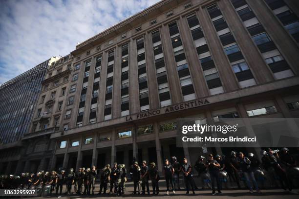 Police officers stand guard during a demonstration against President Javier Milei and recent announcements by Minister of Economy Luis Caputo on...