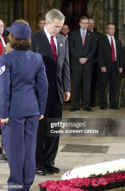 President George W, Bush stands in front of a wreath laid by American service personnel besides the Grave of the Unknown Warrior inside Westminster...