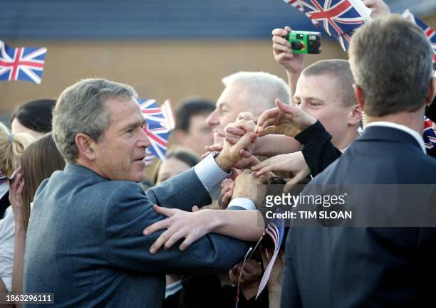 President George W. Bush greets supporters outside Sedgefield Community College in Sedgefield, 21 November 2003 during a visit with British Prime...