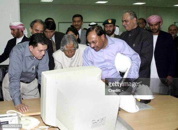 Indian president A.P.J. Abdul Kalam ooks at a computer during a visit to the Umm al-Nar electricity station in Abu Dhabi 18 October 2003, on the...