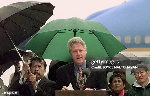 President Bill Clinton speaks to the press 15 November after arriving at McClellan AFB in Sacramento, CA, 15 November. During his statement Clinton...