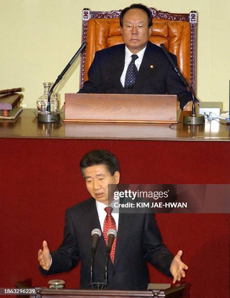 South Korean National Assembly speaker Park Kwan-Yong looks on as South Korean President Roh Moo-Hyun speaks at the National Assembly, 13 October...