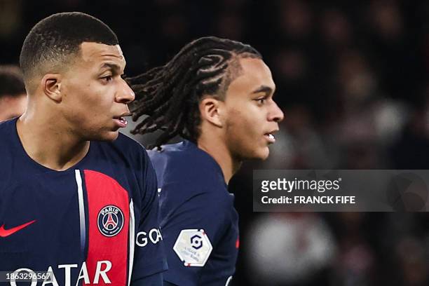 Paris Saint-Germain's French forward Kylian Mbappe and Paris Saint-Germain's midfielder Ethan Mbappe look on during the French L1 football match...