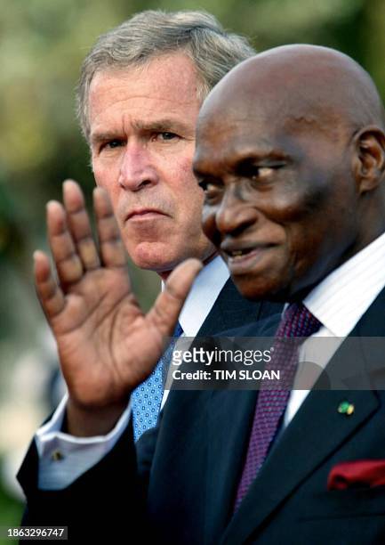 President George W. Bush and Senegalese President Abdoulaye Wade attend the welcoming ceremony 08 July 2003, at the Presidential Palace in Dakar....