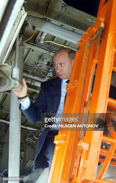Russian President Vladimir Putin climbs on a Russian build Tupolev 160 bomber at the opening of the 6th Moscow International Air Show in the airfield...